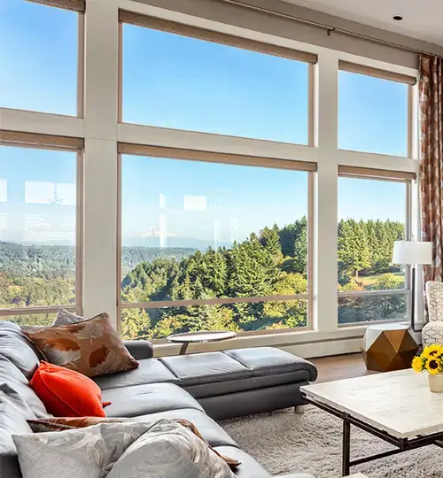 Large picture windows framing a mountain view