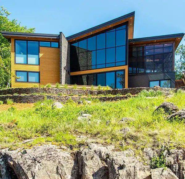 Modern hillside home with full-height window walls